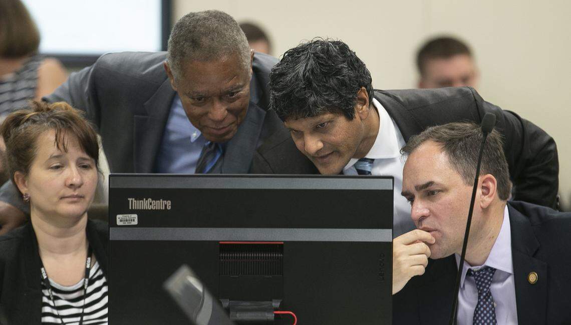 From left, legislative staff member Kara McCray, Sen. Dan Blue, Wake County, Sen. Jay Chaudhuri, Wake County and Sen. Wiley Nickel of Wake County study redistricting maps during a committee meeting on Thursday, September 12, 2019 at the Legislative Office Building in Raleigh, N.C.