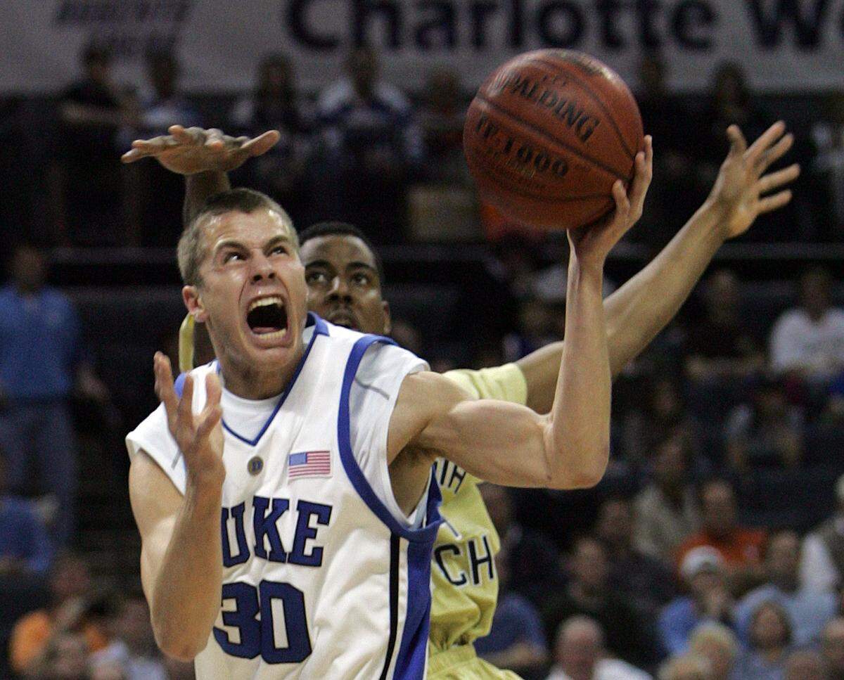Duke’s Jon Scheyer (30) shoots beneath Georgia Tech’s Alade Aminu during the first half of their second round game of the ACC Tournament at the Charlotte Bobcats Arena on Friday, March 14, 2008.