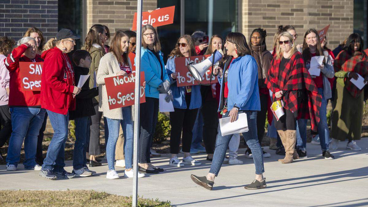 Educators and parents picket outside Fuquay-Varina Elementary School on Thursday.