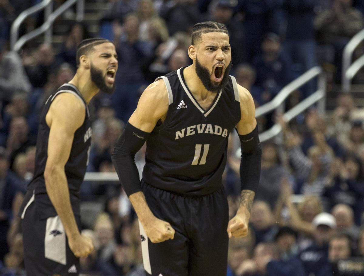 Nevada forwards Cody Martin (11) and twin brother Caleb react after a big basket against New Mexico in the first half of an NCAA college basketball game in Reno, Nev., Saturday, Feb. 9, 2019.