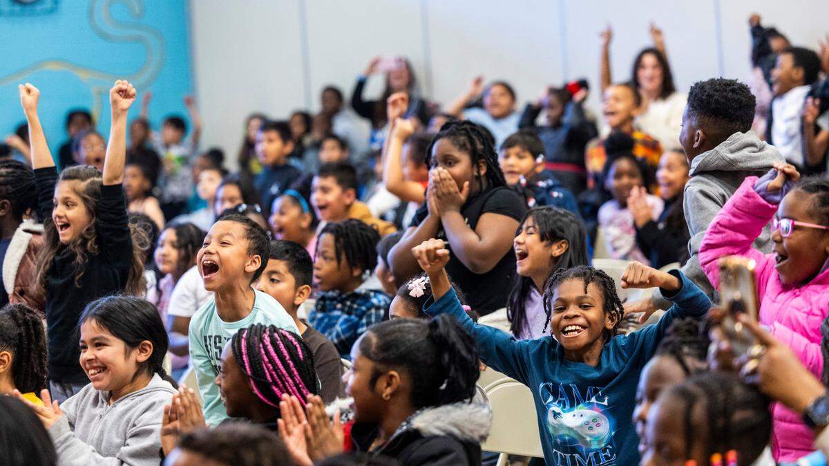 Third-graders at Walnut Creek Elementary School react after learning they were all receiving new bicycles on Wednesday, Dec. 4, 2024. Triangle Spokes Group, which “distributes new bicycles and helmets to less fortunate families during the holiday season,” made the donation.