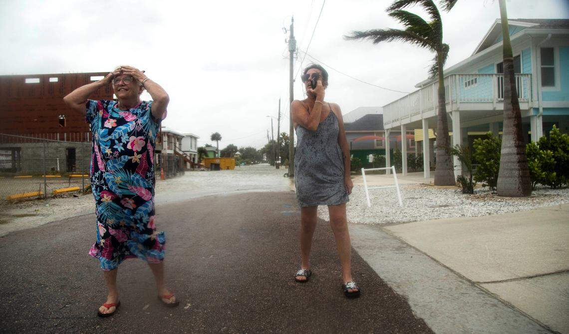 Kathy Cronley and her daughter, Erin take in the outerbands of Hurricane Helent on Fort Myers Beach, Fla. as it passes by on Thursday, Sept. 26, 2024. They are on vacation from Indiana and were staying in a family members home.