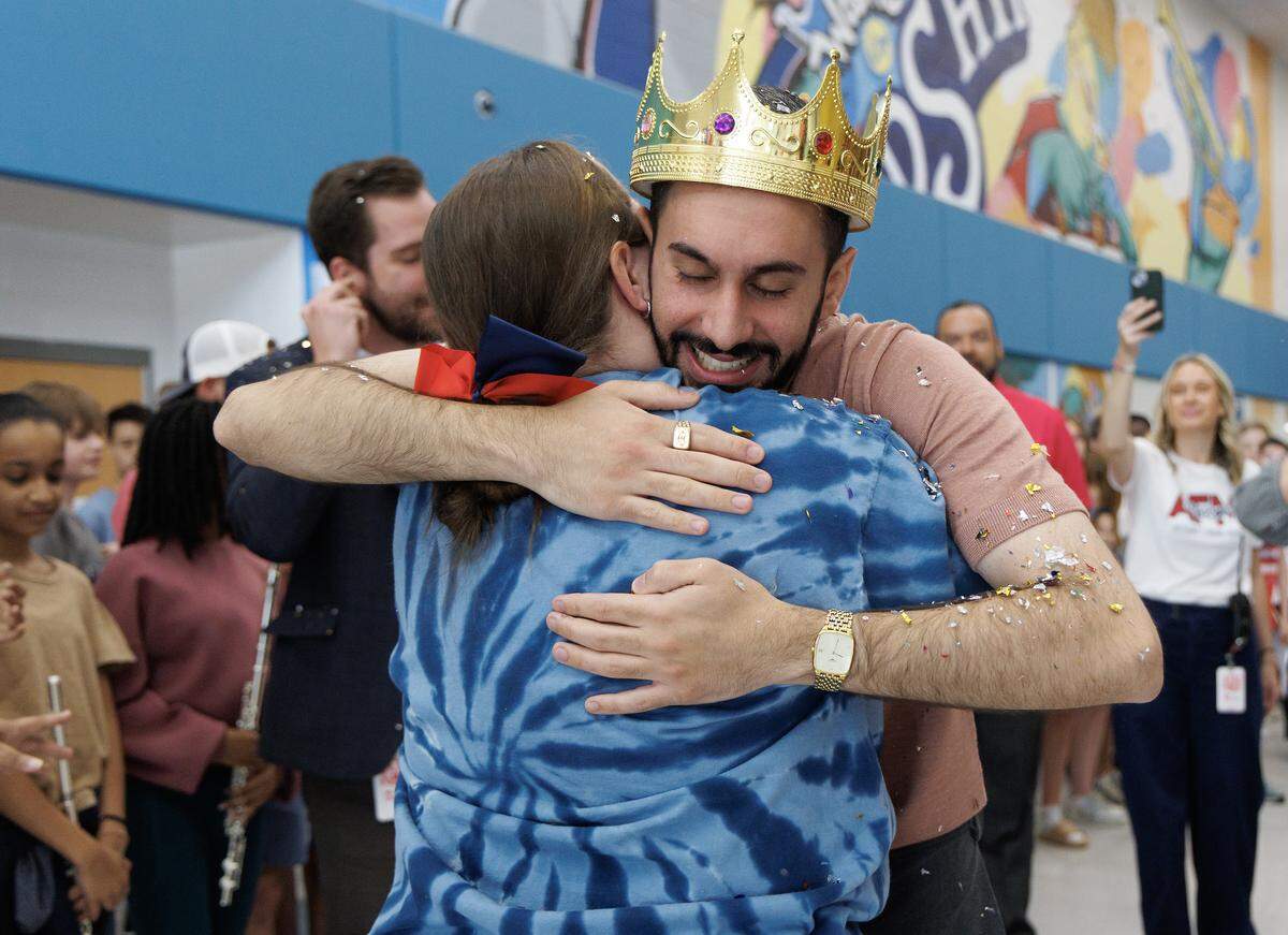 Matin Maani, a seventh-grade social studies teacher at Apex Friendship Middle School, receives a hug from colleague Jennifer Decker following a celebration recognizing him as the 2026 Wake County Teacher of the Year on Thursday, May 21, 2026, in Apex, N.C. 