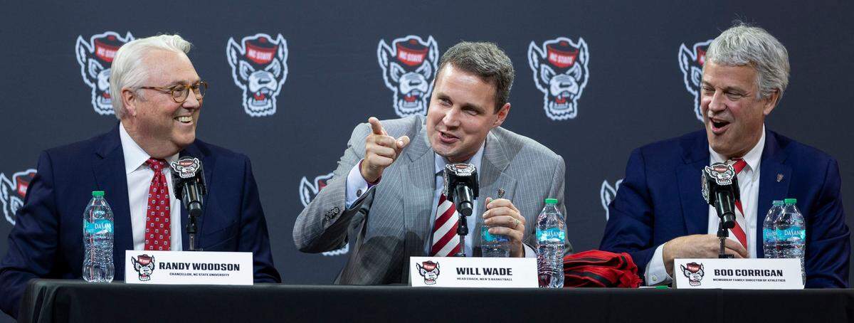 Will Wade, center, flanked by N.C. State Chancellor Randy Woodson and athletic director Boo Corrigan field questions following his introduction at the new Wolfpack men's basketball coach on Tuesday, March 25, 2025 at Reynolds Coliseum in Raleigh, N.C.