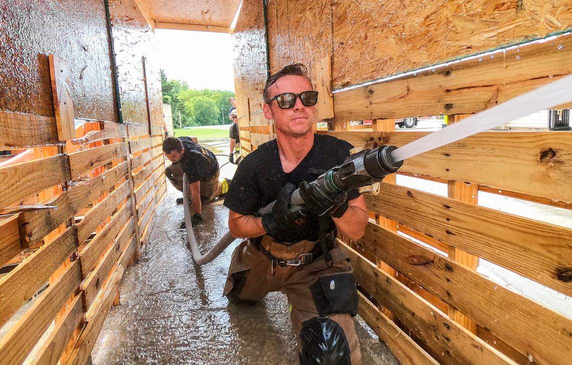 Raleigh firefighter recruits Hugh Long, foreground, and Josh Reeves train at the Keeter Training Center in Raleigh Monday, July 25, 2022. The Raleigh Fire Department has 65 vacancies and a current academy class with 55 graduates expected this fall.