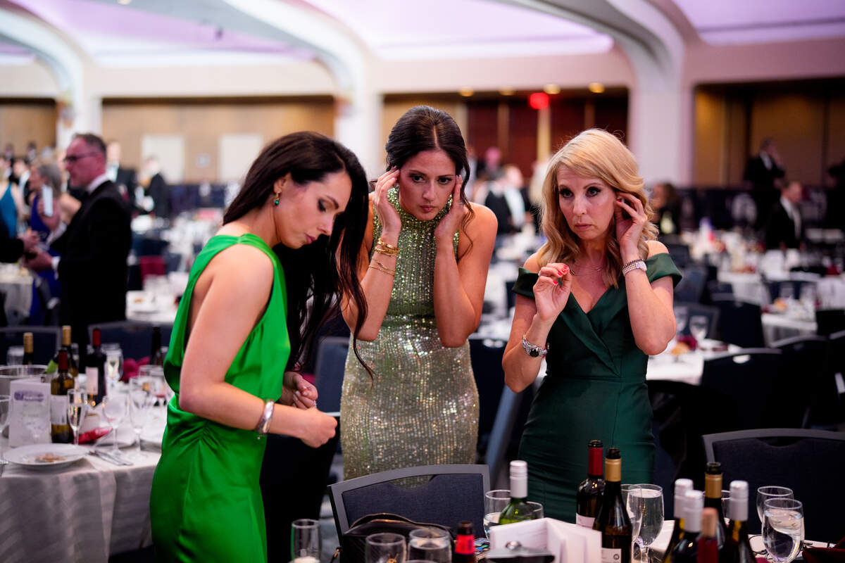 WASHINGTON, DC - APRIL 25: Bloomberg White House Correspondent Courtney Subramanian (C) and others work from the ballroom following a shooting incident at the annual White House Correspondents Association Dinner April 25, 2026 in Washington, DC. According to reports, President Donald Trump, along with other government officials, were evacuated from the Washington Hilton after a shooting incident.