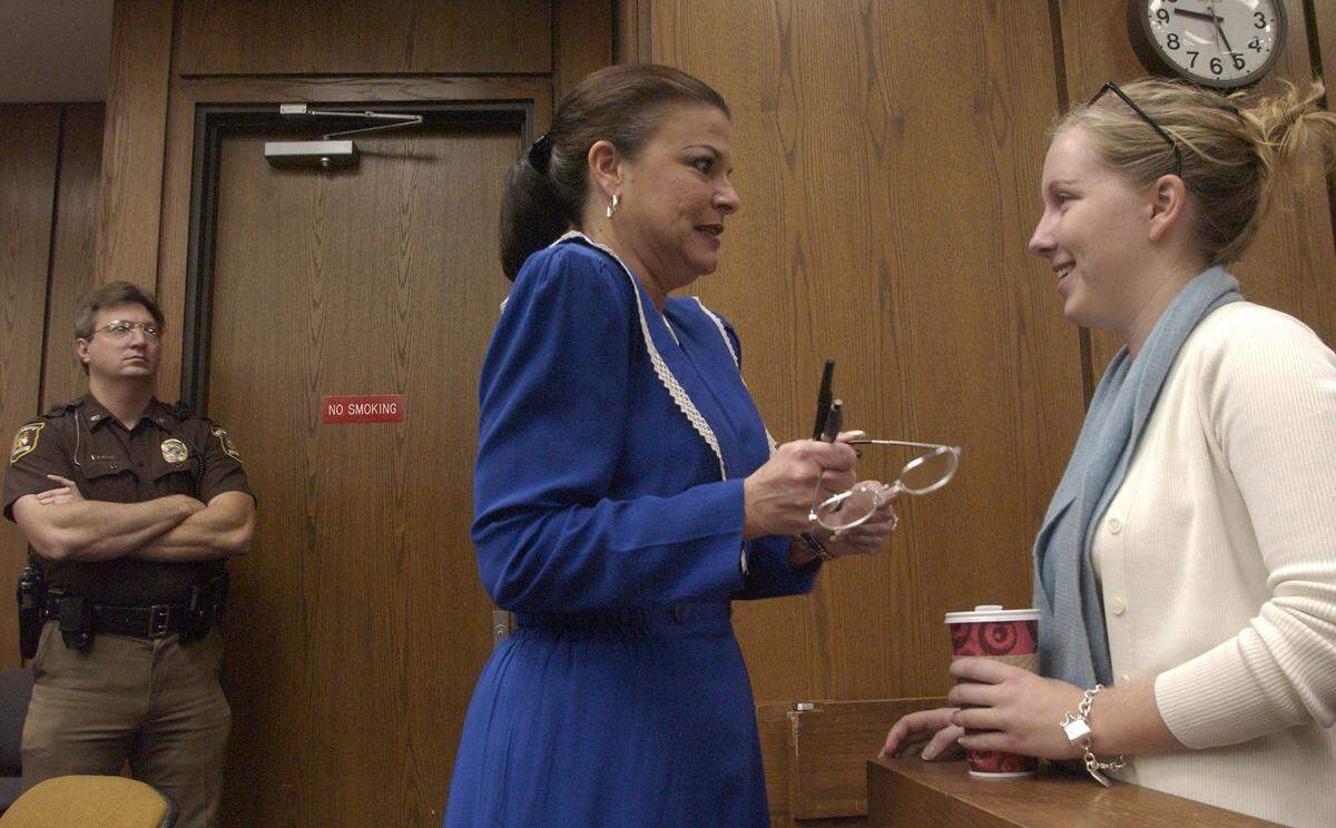 Assistant DA Freda Black (center) speaks with Caitlin Atwater Friday morning prior to the start of court. Atwater didn’t remain in the courtroom as the jury returned less than two hours later to convict her mother’s killer Michael Peterson.