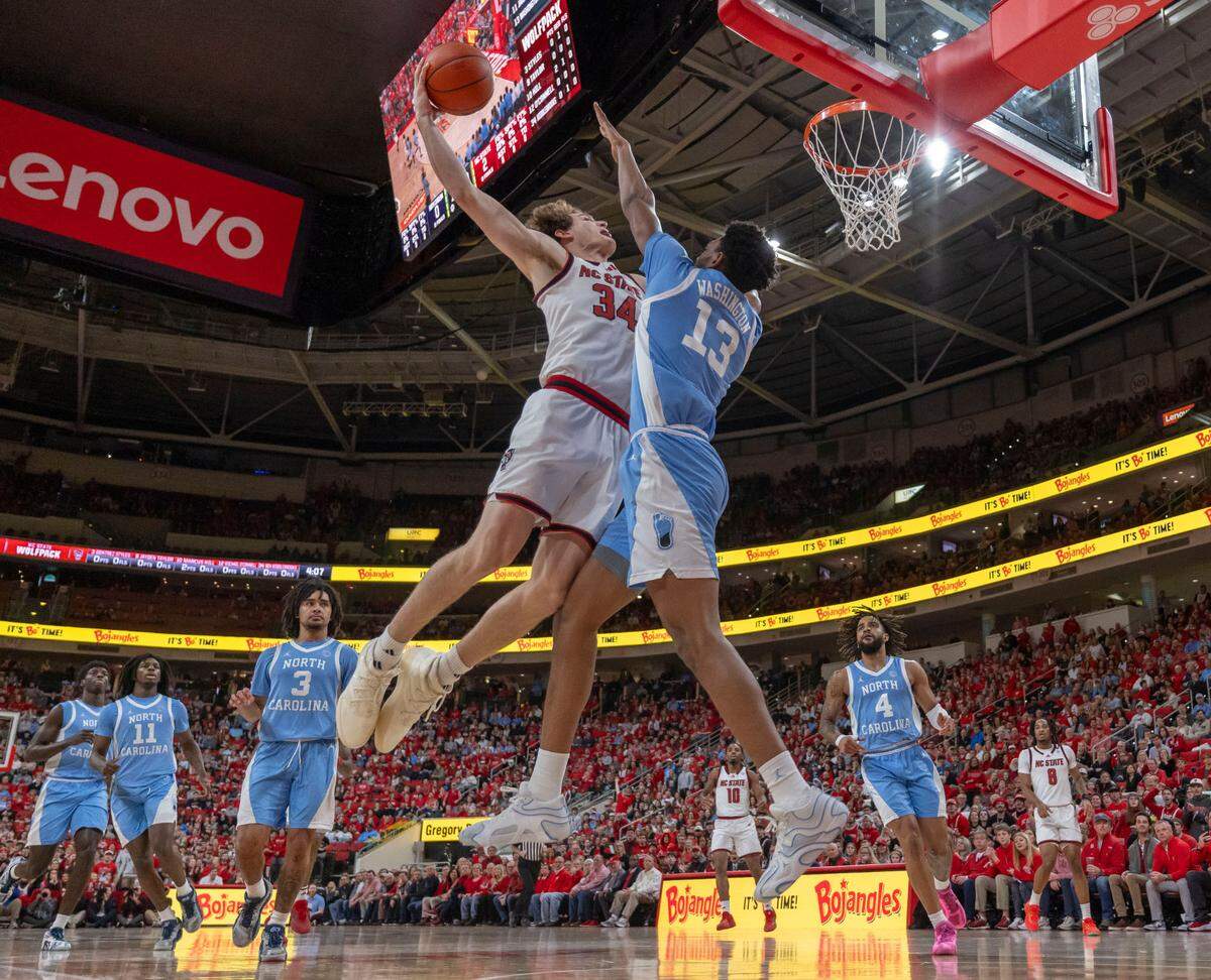 North Carolina forward Jalen Washington (13) defends N.C. State’s Ben Middlebrooks (34) in the first half on Saturday, January 11, 2025 at Lenovo Center in Raleigh, N.C.