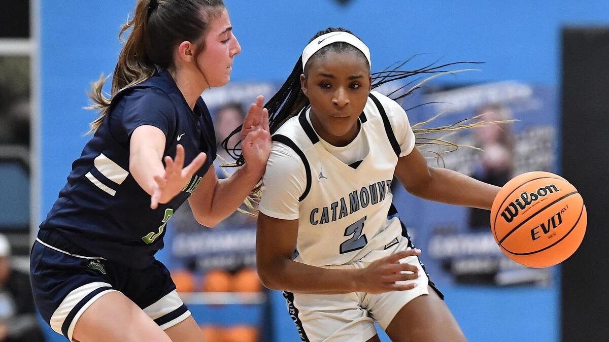 Panther Creek’s Taylor Barner (2) drives the ball downcourt against Green Level’s Stella Eckhart (3). The Panther Creek Catamounts and the Green Level Gators met in a NCHSAA 4A first round basketball playoff game in Cary, N.C. on February 21, 2023.