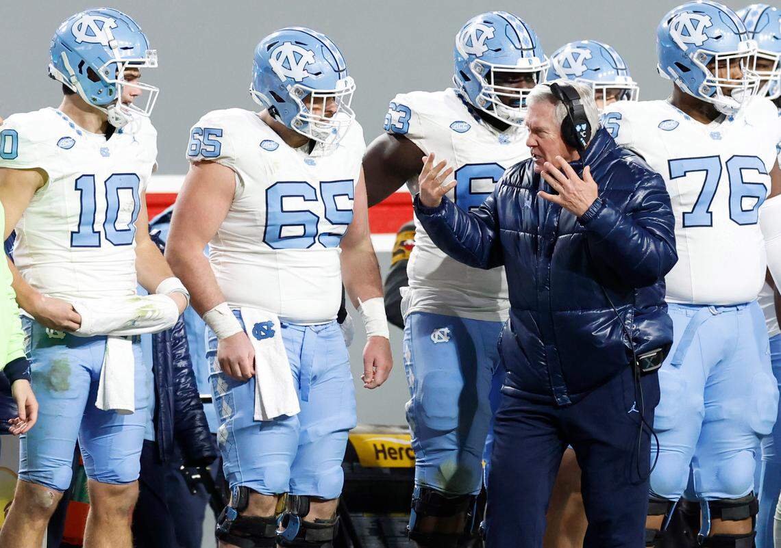 North Carolina head coach Mack Brown encourages the offense including quarterback Drake Maye (10) during the second half of N.C. State’s 39-20 victory over UNC at Carter-Finley Stadium in Raleigh, N.C., Saturday, Nov. 25, 2023.
