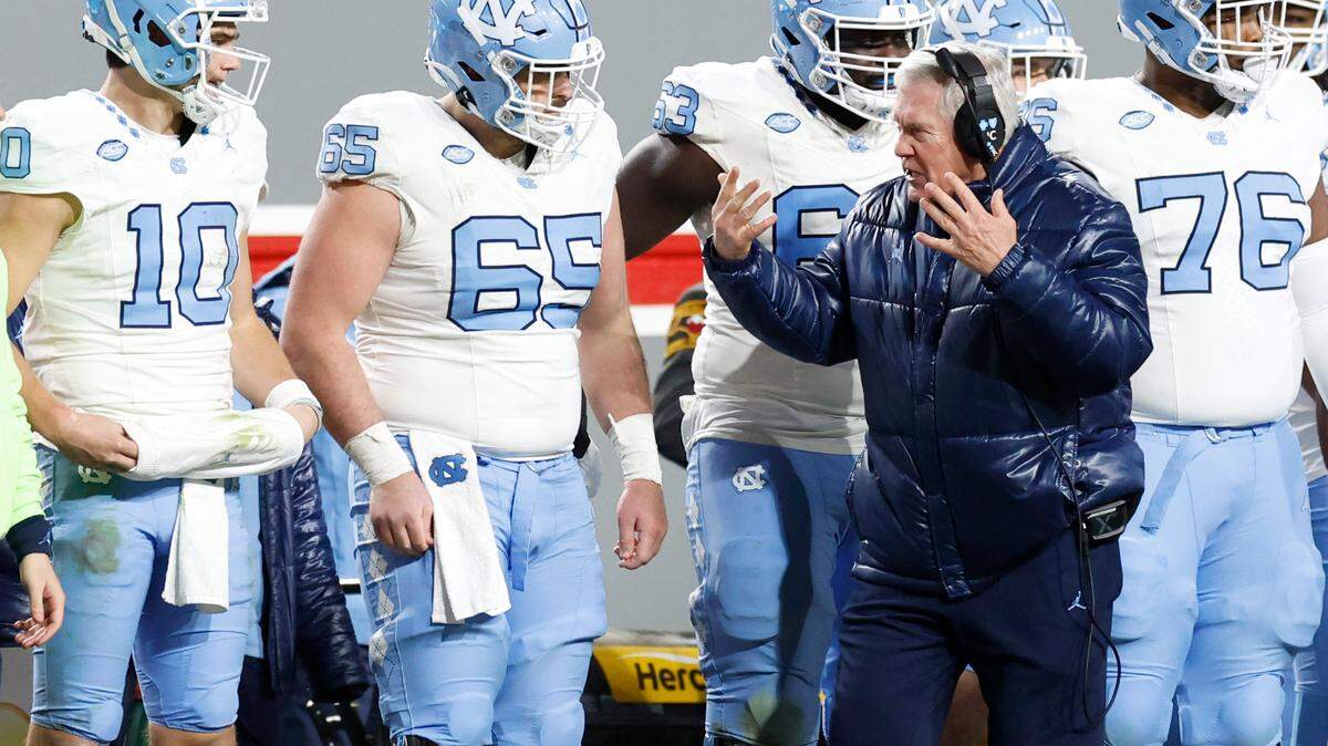 North Carolina head coach Mack Brown encourages the offense including quarterback Drake Maye (10) during the second half of N.C. State’s 39-20 victory over UNC at Carter-Finley Stadium in Raleigh, N.C., Saturday, Nov. 25, 2023.