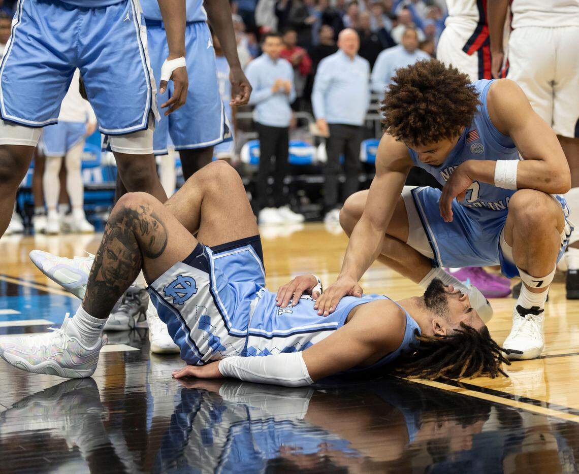 North Carolina guard Seth Trimble (7) checks on teammate R.J. Davis (4) after a hard fall in the second half against Ole Miss during the first round of the NCAA Tournament on Friday, March 21, 2025 at Fiserv Forum in Milwaukee, Wisconsin.