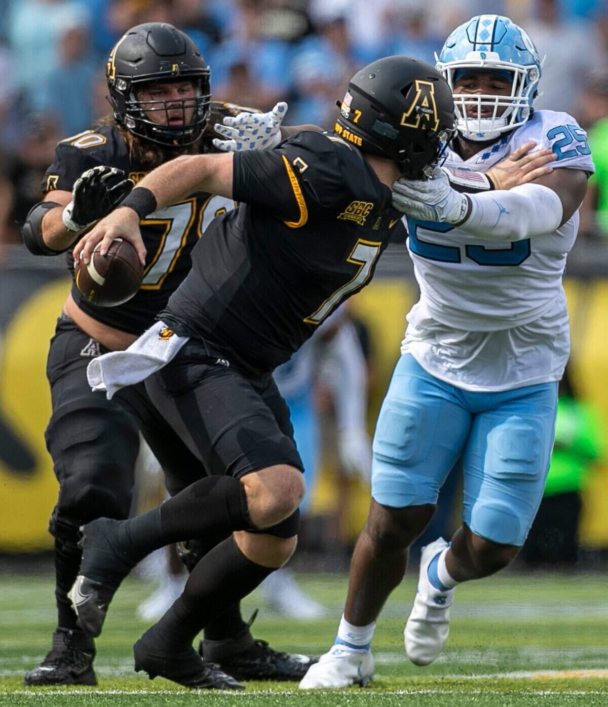 North Carolinas Caiman Rucker (25) works to sack Appalachian State quarterback Chase Brice (7) in the fourth quarter on Saturday, September 3, 2022 at Kidd Brewer Stadium in Boone, N.C.