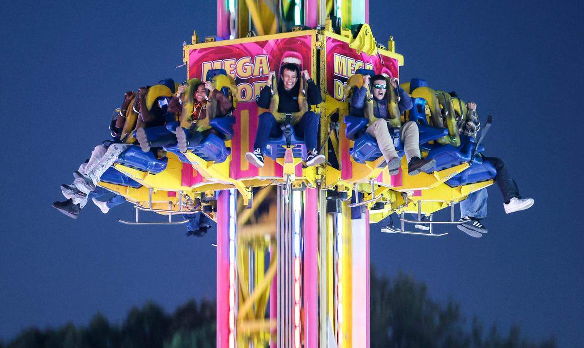 Fairgoers ride the Mega Drop at the N.C. State Fair in Raleigh, N.C., Thursday evening, Oct. 24, 2024.