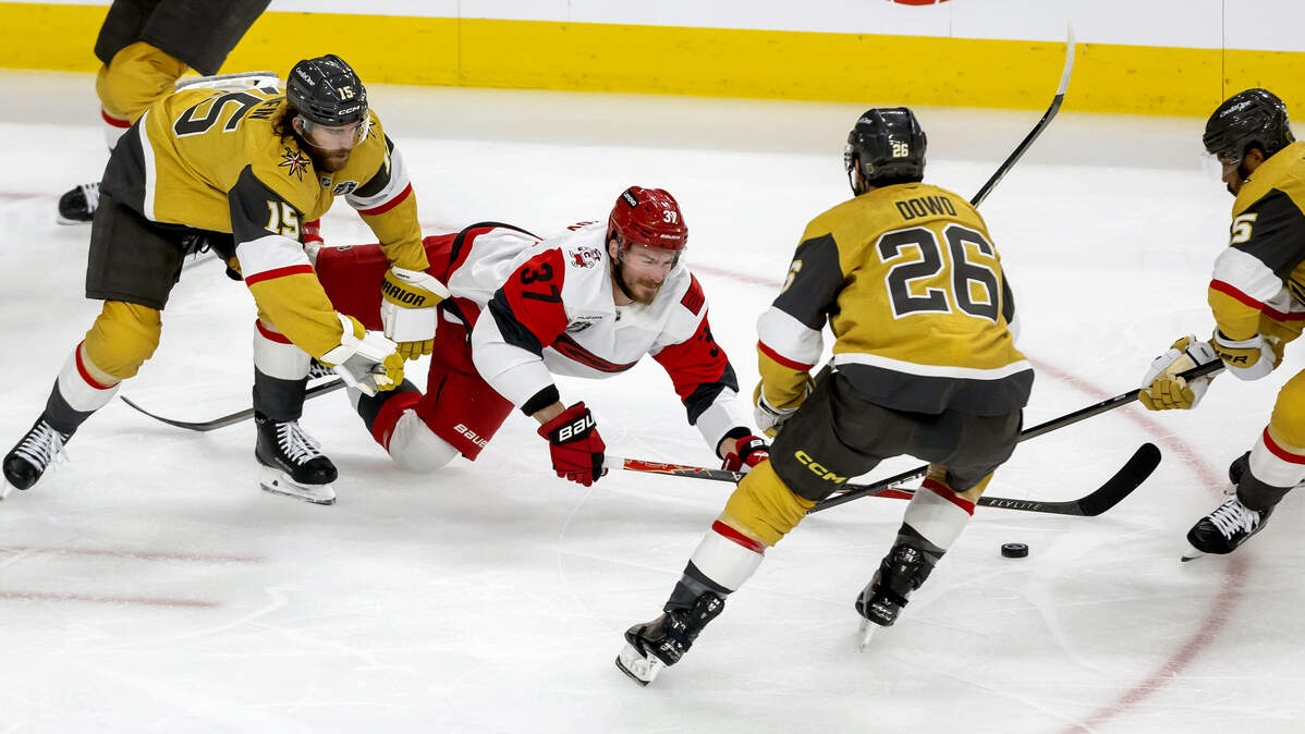 Vegas defenseman Noah Hanifin (15) checks Carolina Hurricanes right wing Andrei Svechnikov (37) to the ice in the first period, as teammates Noah Hanifin (15) and Keegan Kolesar (55) take control of the puck in Game 3 of the Stanley Cup Final, on Saturday, June 6, 2026 at T-Mobile Arena in Las Vegas, NV.