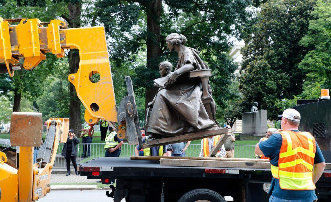 Crews remove the monument to the North Carolina Women of the Confederacy at the North Carolina State Capitol in Raleigh, N.C., Saturday, June 20, 2020.