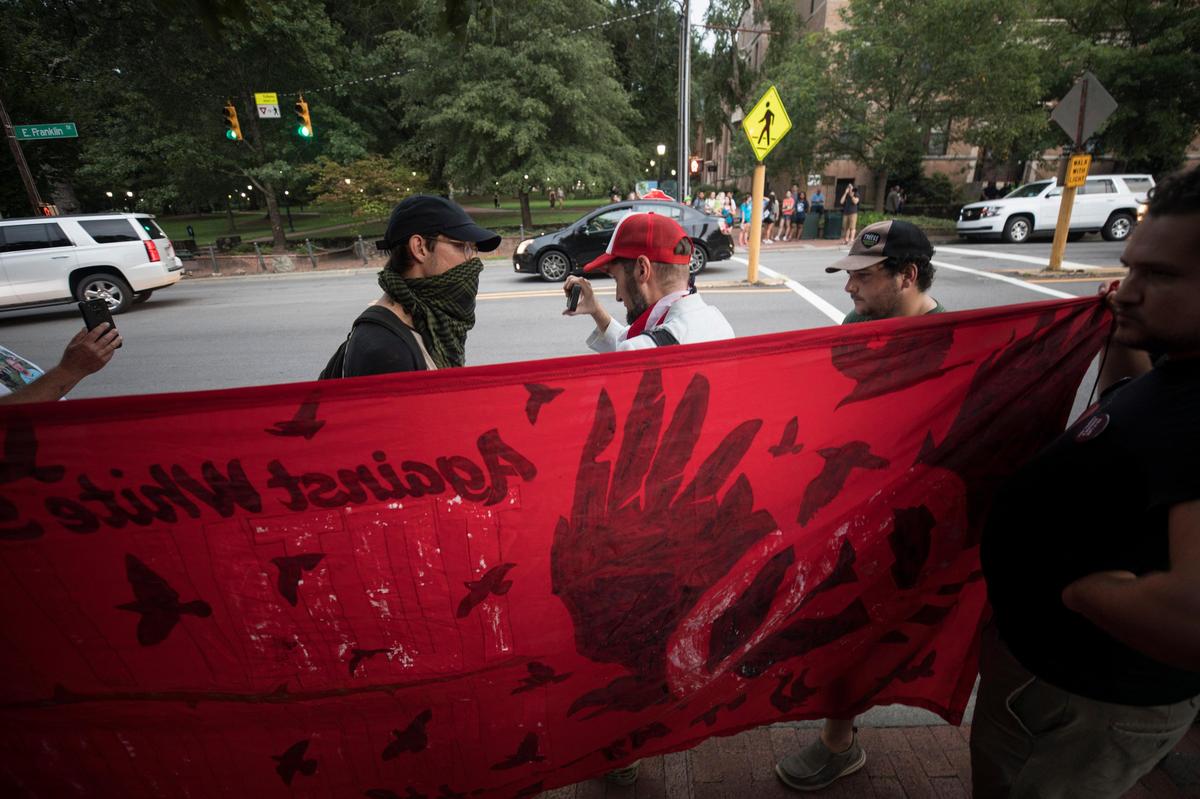 Cody Gall, middle, disrupts a gathering of students and activists at Peace and Justice Plaza on Tuesday, August 20, 2019.