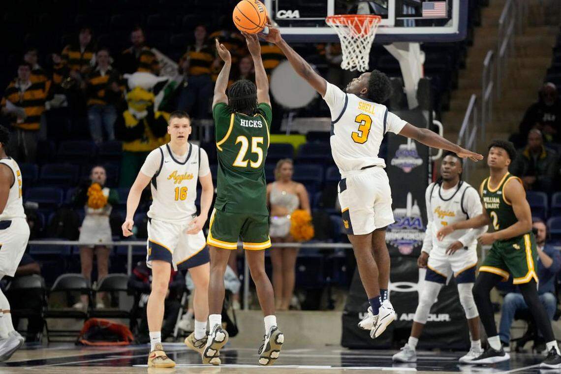 Miles Hicks #25 of the William & Mary Tribe takes a jump shot over drives to the basket past Camian Shell #3 of the North Carolina A&T Aggies in the second half during the first round of the CAA Mens Basketball Tournament at the Entertainment & Sports Arena on March 8, 2024 in Washington, DC.  