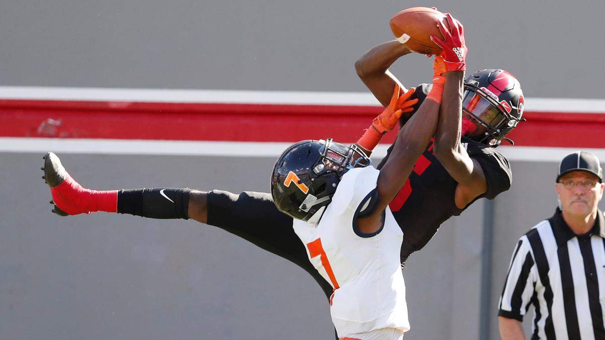 Rolesville’s Noah Rogers (5) makes a the 13-yard touchdown reception as Vance’s Nathaniel Spindle (7) defends during the first half of Rolesville High School’s game against Vance High School in the NCHSAA 4AA state championship at Carter-Finley Stadium in Raleigh, N.C., Saturday, May 8, 2021.