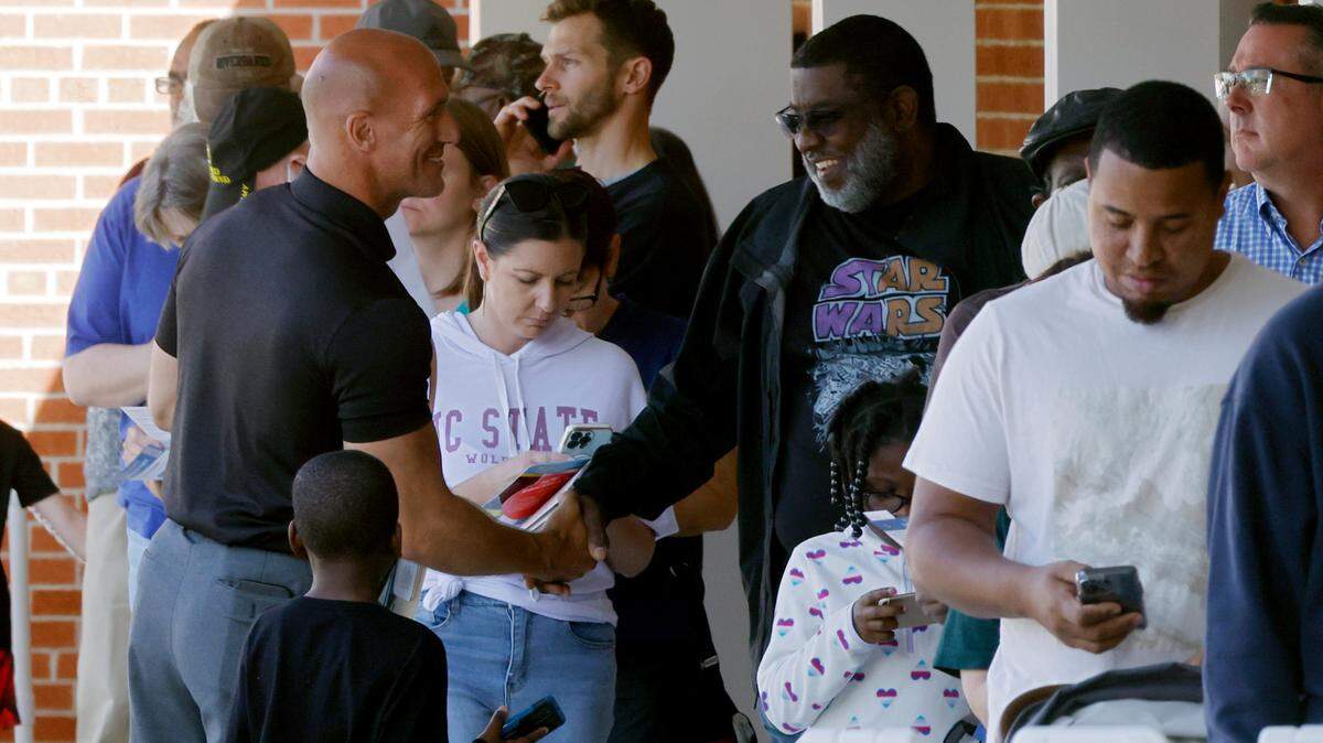 Candidate Steve Bergstrom greets people standing in line outside an early voting site in Holly Springs, N.C. on Nov. 4, 2022. Bergstrom lost his race for the Wake County School Board.