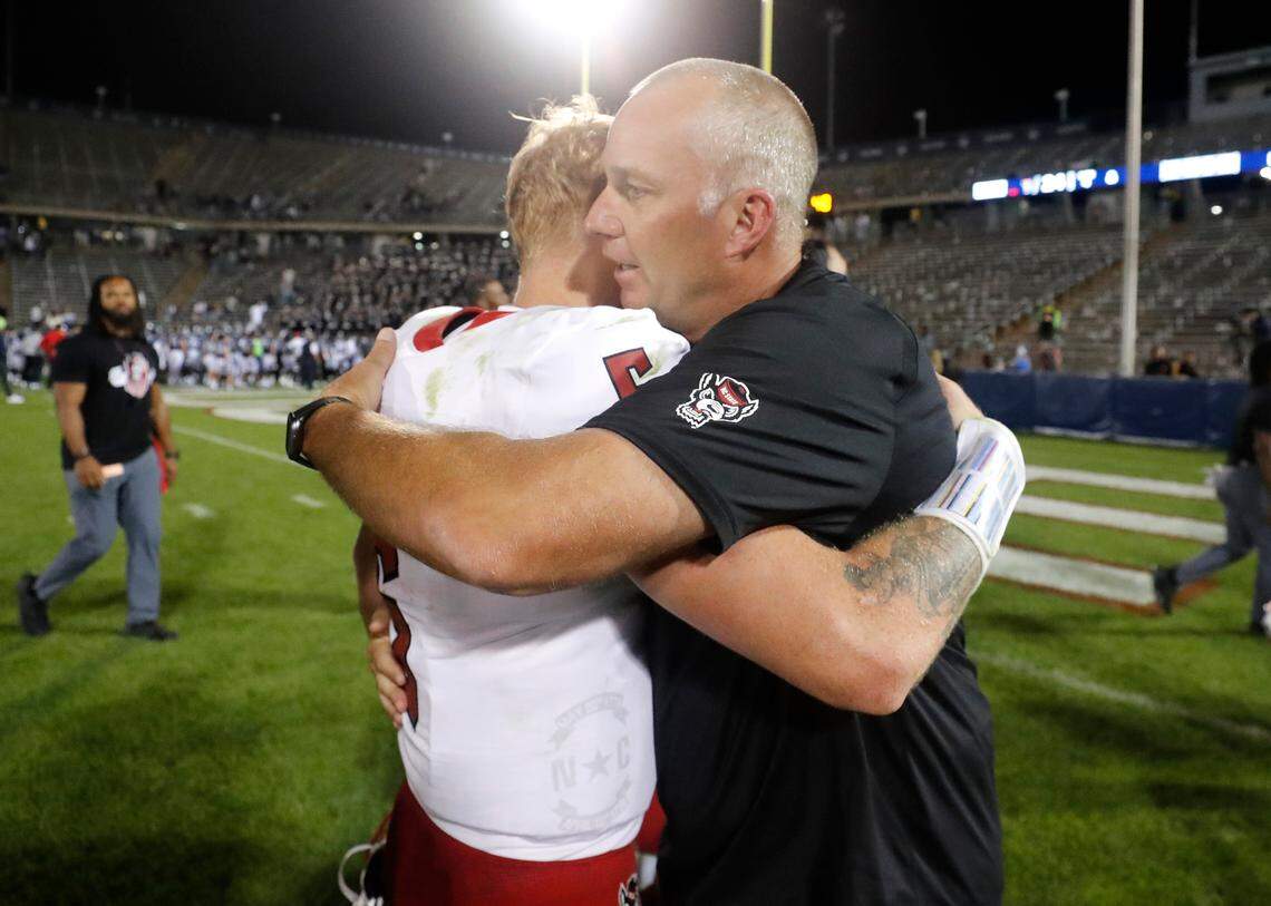 N.C. State head coach Dave Doeren and quarterback Brennan Armstrong (5) hug after the Wolfpack’s 24-14 victory over UConn at Rentschler Field in East Hartford, Conn. Thursday, August 31, 2023.