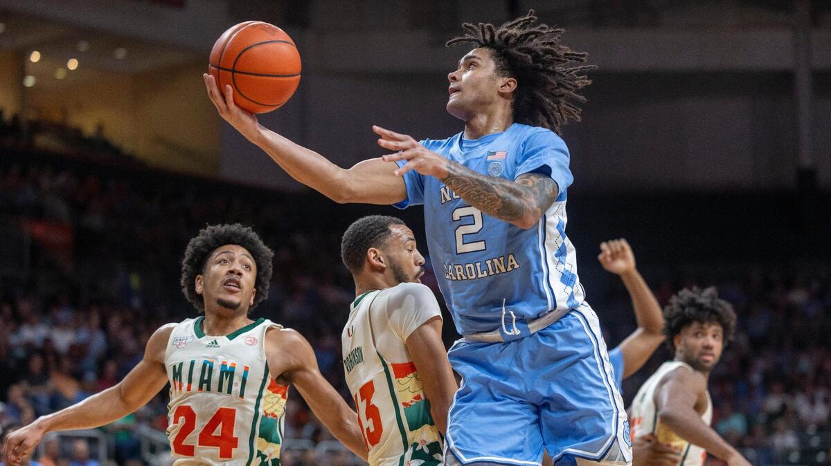 North Carolina’s Elliot Cadeau (2) drives to the basket against Jakai Robinson (13) in the first half on Saturday, February 10, 2024 at the Watsco Center in Coral Gables, Florida. Cadeau scored 11 points in the first half.