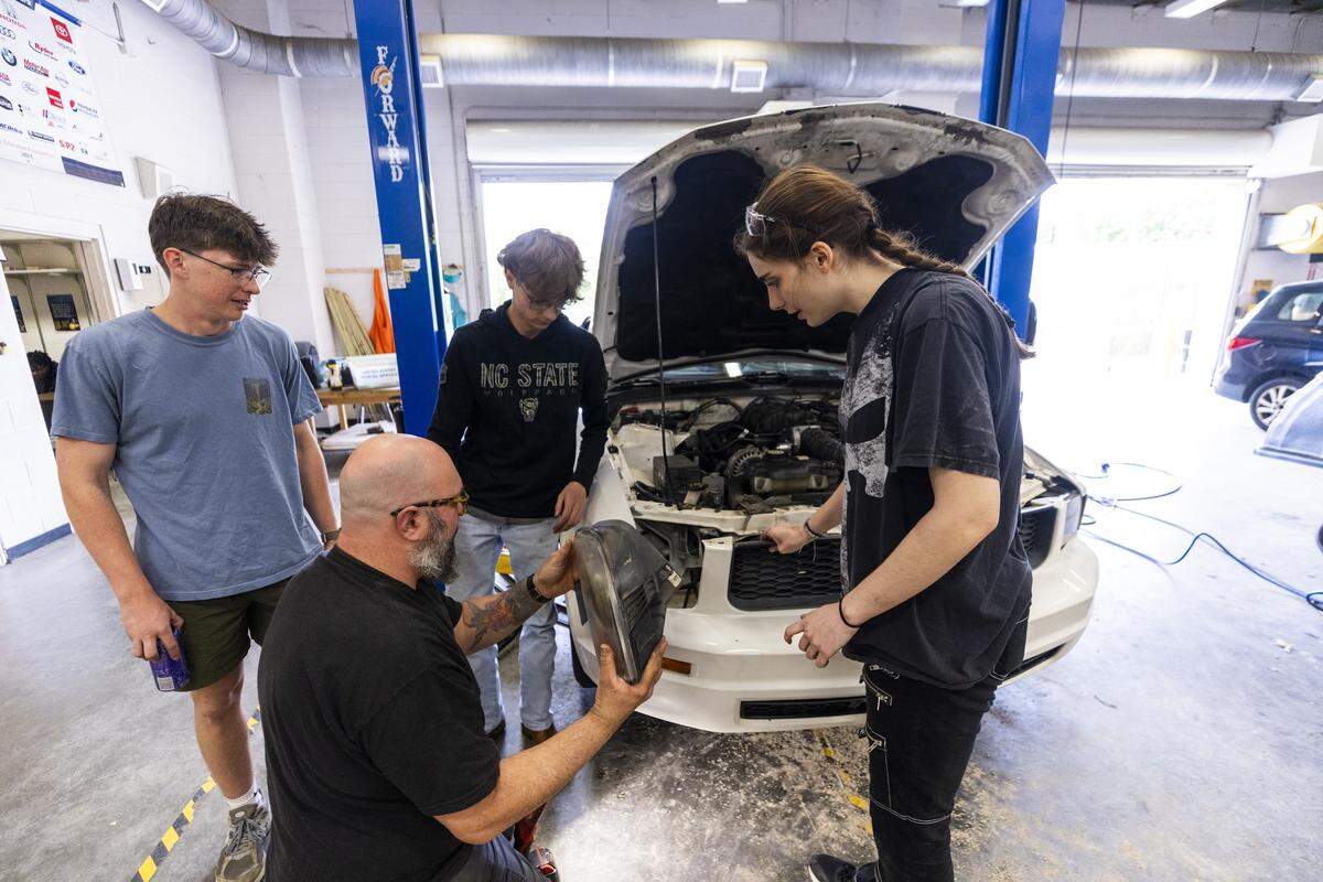 Trip Triplett, lower center, leads an Automotive Technology class at East Wake High School in Wendell on Wednesday, May 6, 2026.