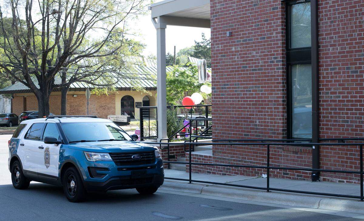 A Raleigh Police vehicle is shown parked outside the Signature 1505 apartments on Hillsborough Street on Wednesday, April 7, 2021in Raleigh, N.C. as officials continue to investigate the death of resident Christina Maria Matos.