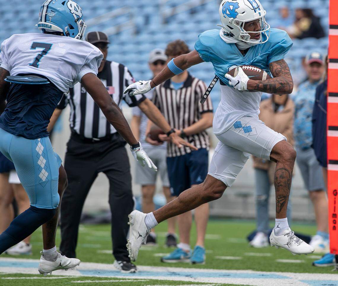 North Carolina wide receiver Kobe Paysour (8) looks for running room after a pass reception from quarterback Drake Maye during a scrimmage at the Tar Heels’ open practice on Saturday, March 25, 2023 at Kenan Stadium in Chapel Hill. N.C.