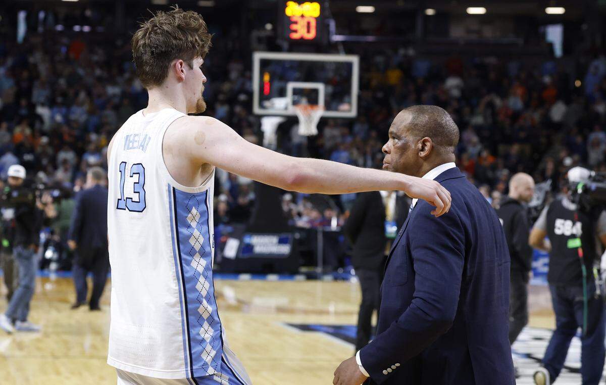 North Carolina's Henri Veesaar (13) heads to hug  head coach Hubert Davis after VCU’s 82-78 overtime victory over UNC in the first round of the NCAA Men’s Basketball Tournament at  Bon Secours Wellness Arena in Greenville, S.C., Thursday, March 19, 2026.