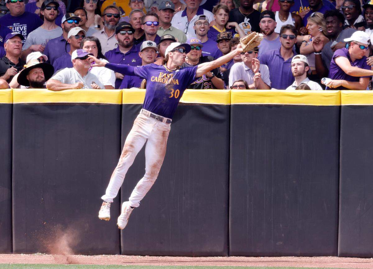 East Carolina’s Jacob Jenkins-Cowart (30) has the ball on his glove, but can’t pull it in, resulting in a double by Texas’ Trey Faltine in the bottom of the seventh during Texas’ 9-8 victory over ECU in the Greenville Super Regional at Clark-LeClair Stadium Saturday, June 11, 2022.