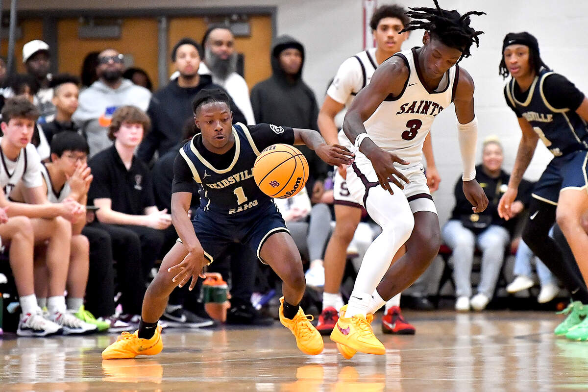 Reidsville’s Dionte Neal (1) forces the turnover against St. Anne’s-Belfield’s Danzelle Bullock Coles (3) during the second half. The Reidsville Rams and the St. Anne -Belfield (VA) Saints met in the finals of the Day’Ron Sharpe bracket of the John Wall Holiday Invitational in Raleigh, N.C. on December 30. 2024.