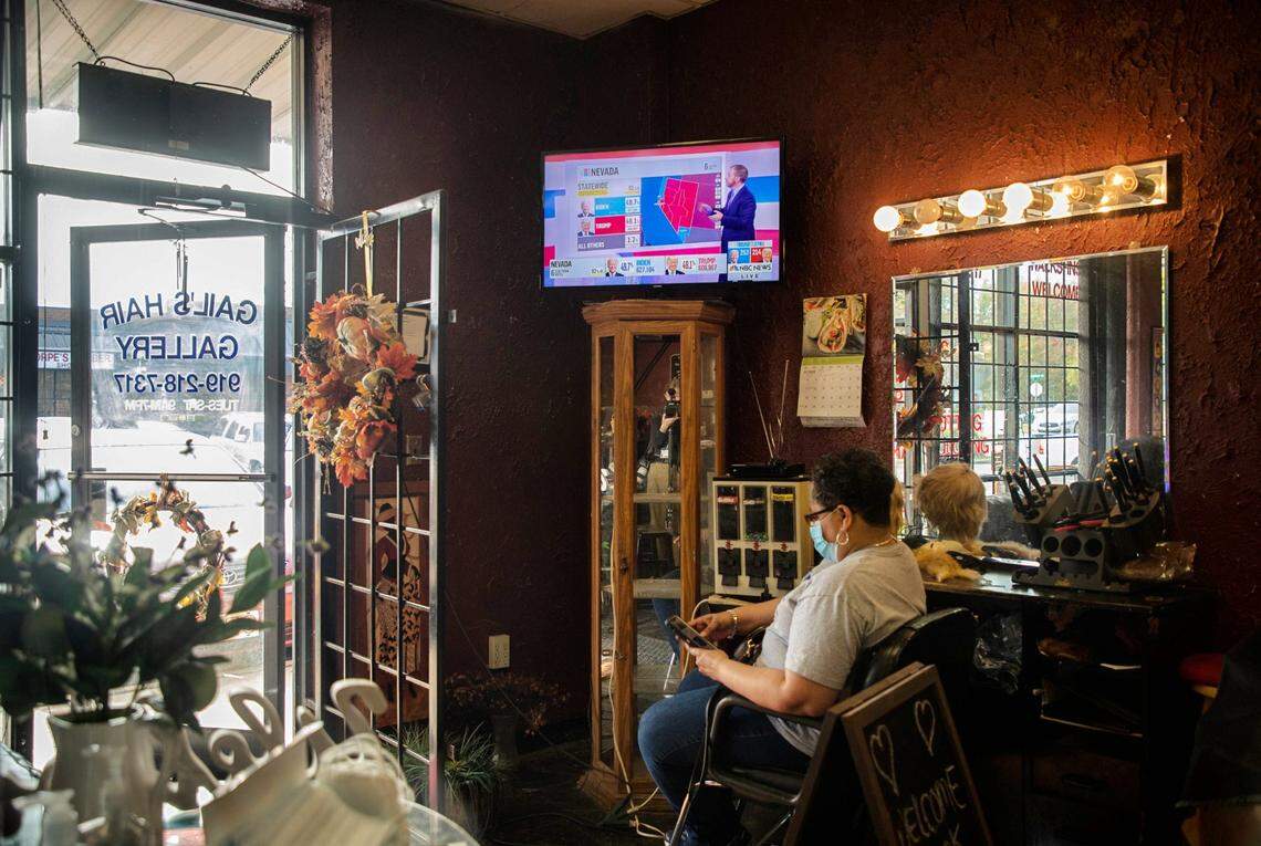 A television screen shows a map of projected election results in the 2020 presidential race as absentee ballots are being counted in several states, inside GailÕs Hair Gallery, on Friday, Nov. 6, 2020, in Durham, N.C.