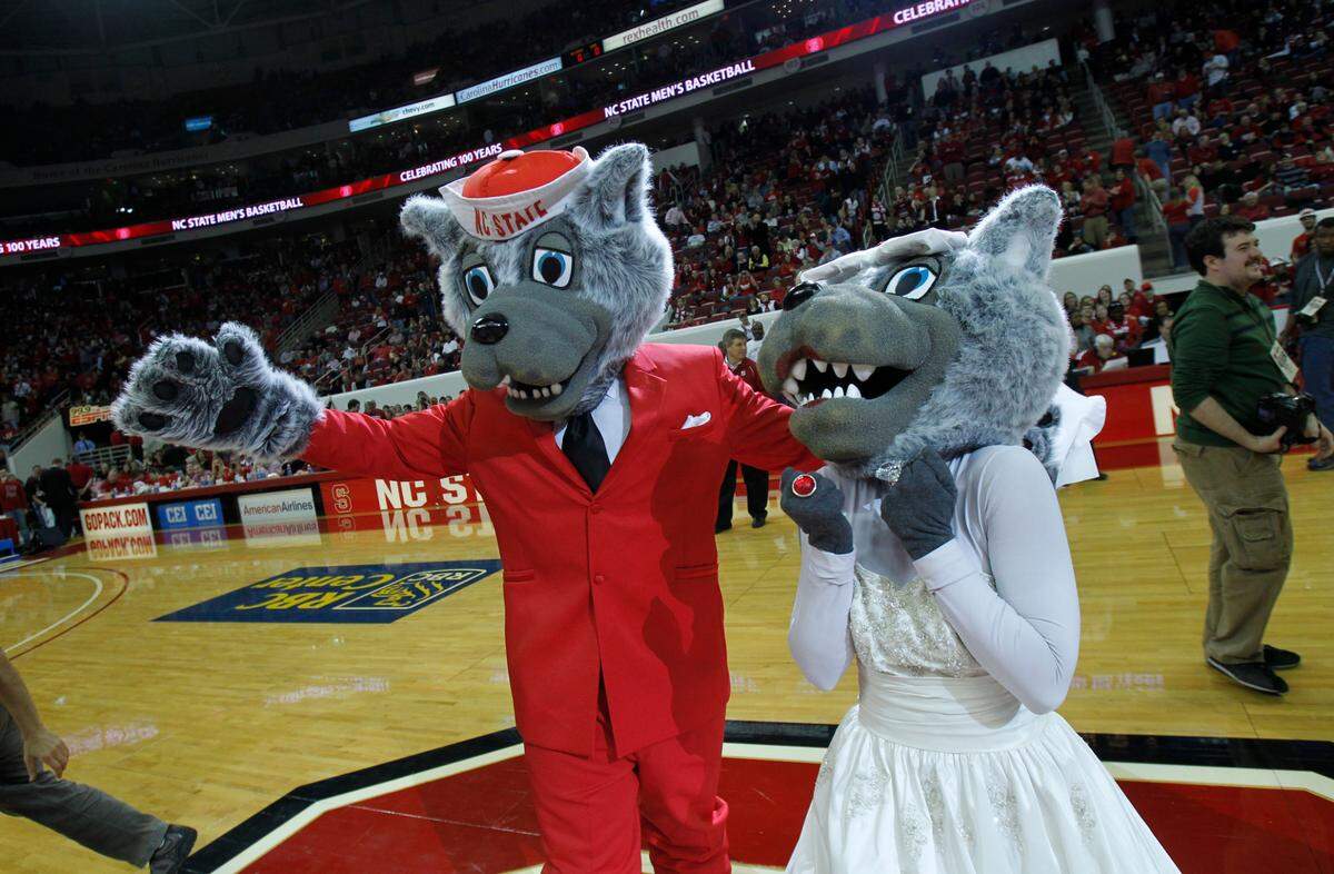 Mr. and Ms. Wuf celebrate nearly 30 years of marriage at halftime at N.C. State’s game with Wake Forest at the RBC Center in Raleigh. The Wake Forest Demon Deacon mascot presided, as he did when the Wufs first took their vows Feb. 28, 1981, at Reynolds Coliseum. That photo, Page 4B. ETHAN HYMAN - ehyman@newsobserver.com