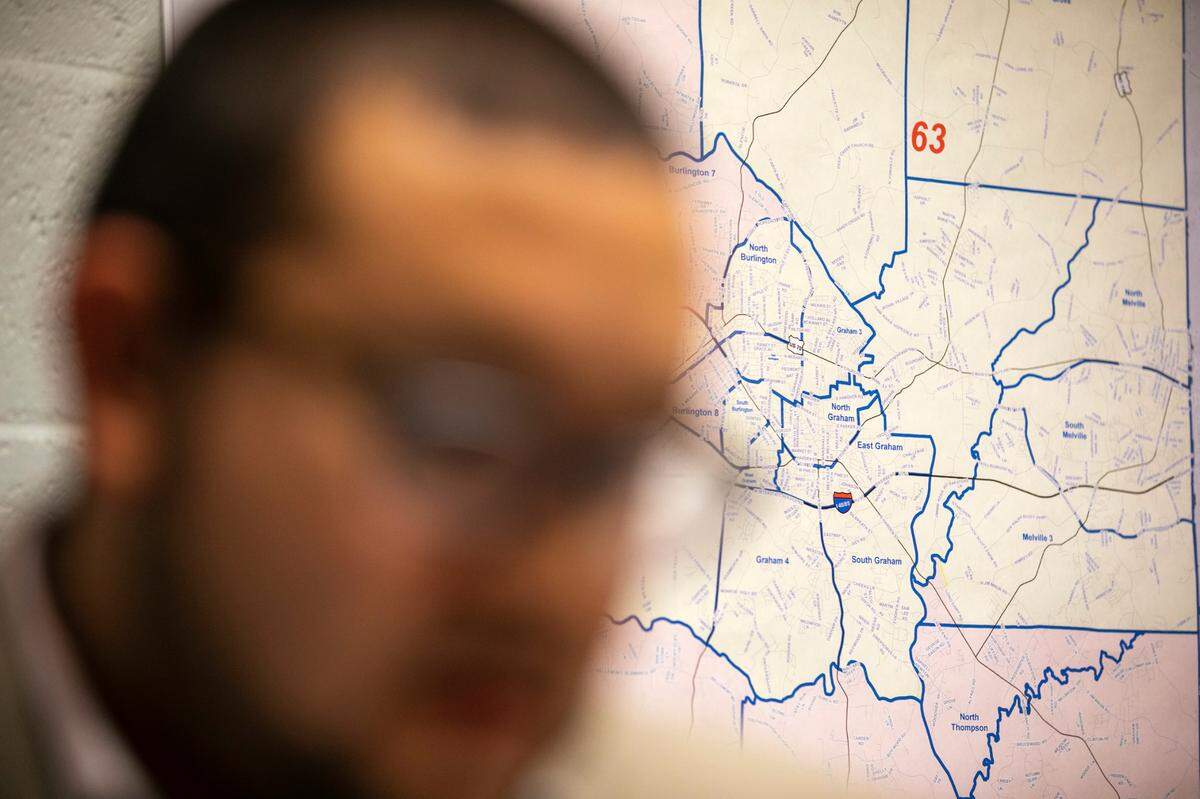 Ricky Hurtado, a Democratic candidate for the North Carolina state house, strategizes inside his campaign headquarters, in Graham, N.C., Tuesday, March 10, 2020, in front of a map of Alamance County. He is the first Latino candidate to run for North Carolina’s House of Representatives.