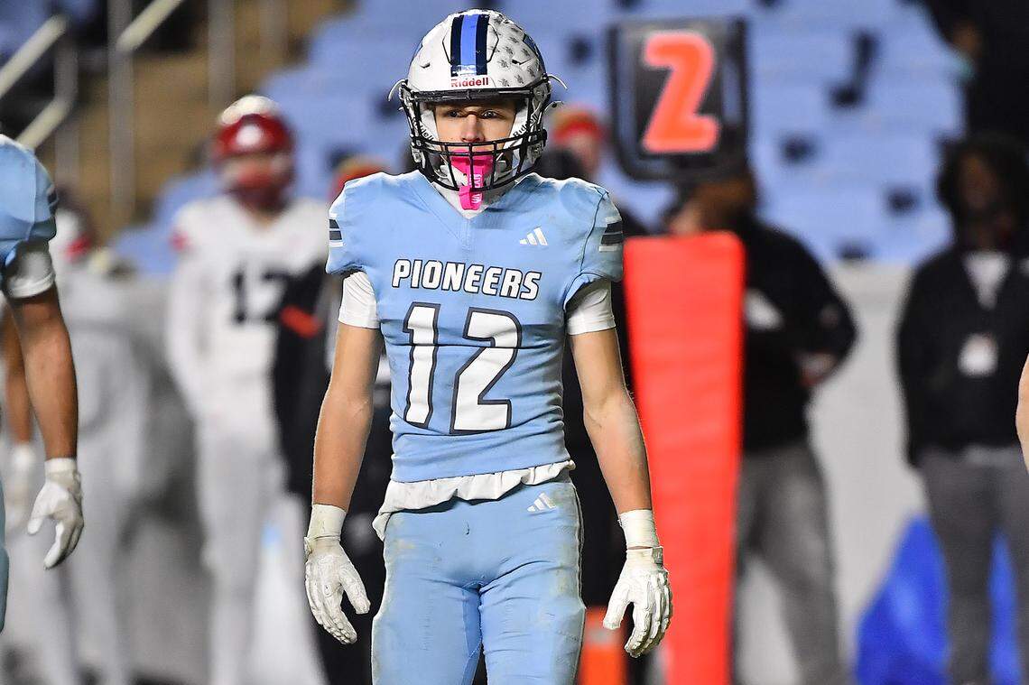 Watauga's Evan Burroughs (12) looks to the sidelines between downs in the 6A Championship Game against Middle Creek. The Middle Creek Mustangs and the Watauga Pioneers met in the NCHSAA 6A Football Championship game in Chapel Hill, N.C. on December 12, 2025. 