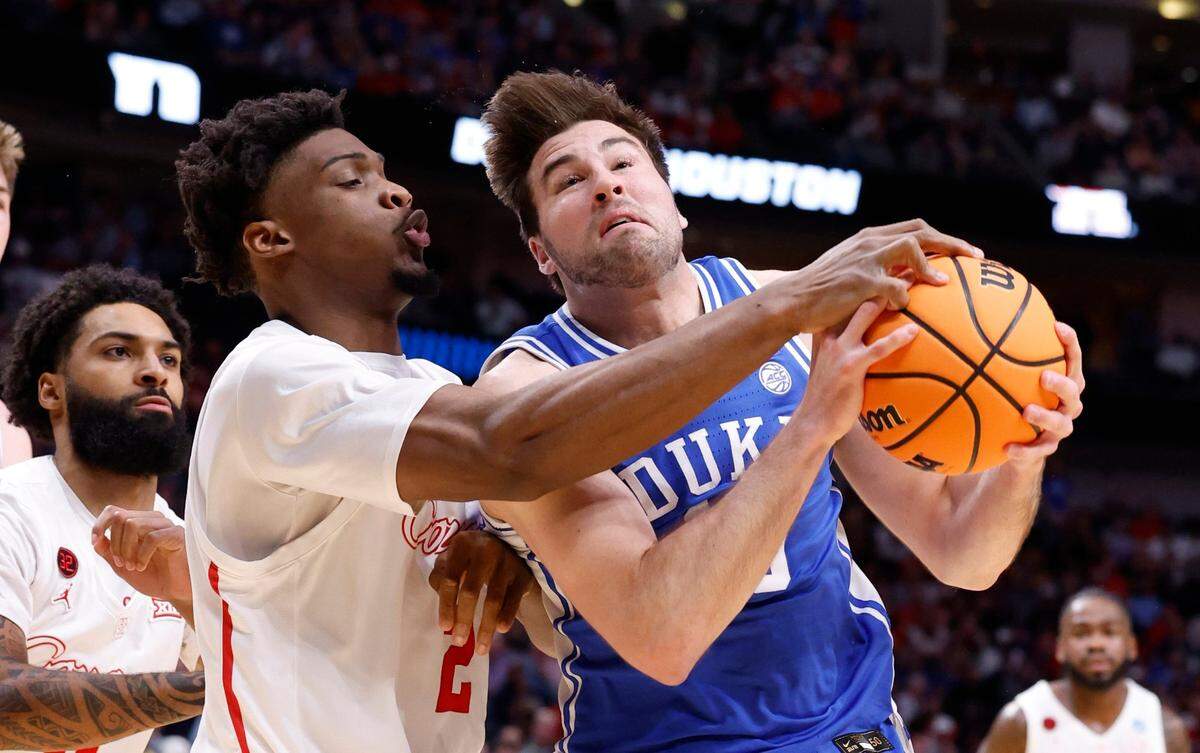 Duke’s Ryan Young (15) keeps the ball from Houston’s Cedric Lath (2) during the first half of Duke’s game against Houston in their NCAA Tournament Sweet 16 game at the American Airlines Center in Dallas, Texas, Friday, March 29, 2024.