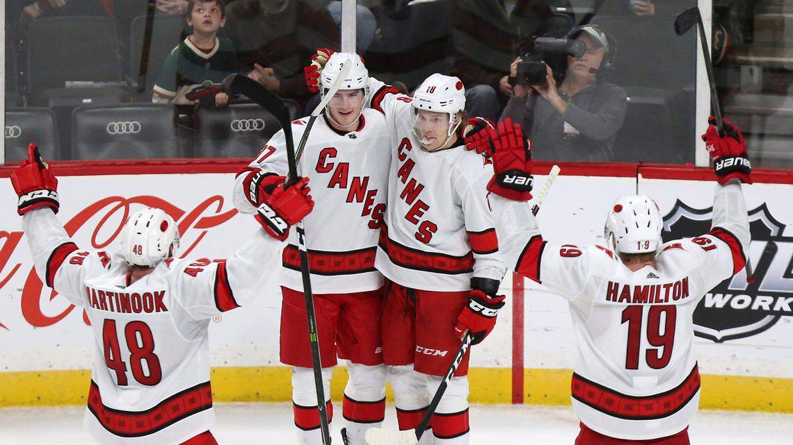 Carolina Hurricanes’ Andrei Svechnikov of Russia (37) celebrates with teammates Ryan Dzingel (18), Jordan Martinook (48) and Dougie Hamilton (19) after Svechnikov scored the game winning goal against Minnesota during overtime of an NHL hockey game Saturday, Nov. 16, 2019, in St. Paul, Minn. Carolina won 4-3 in overtime