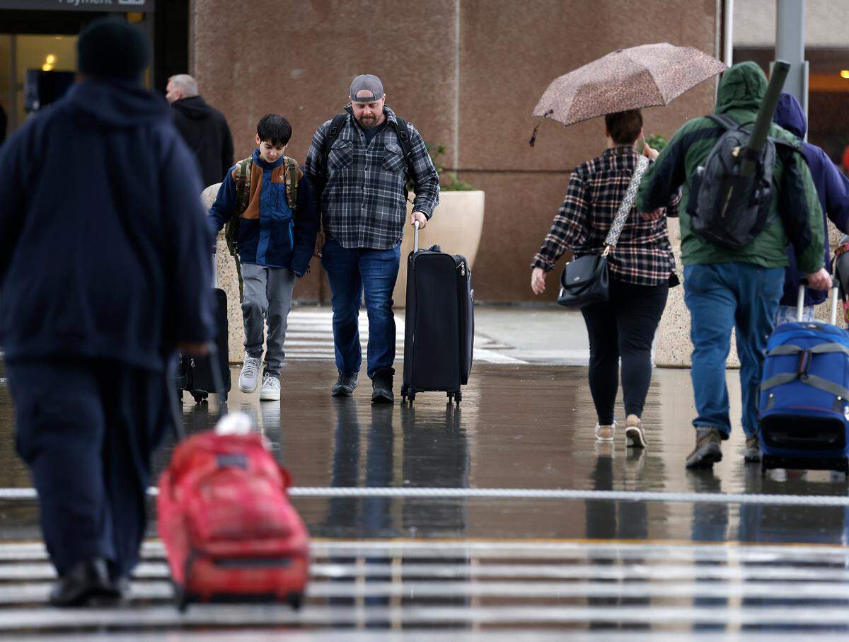 Travelers arrive at Raleigh-Durham International Airport on Thursday, Dec. 22, 2022.