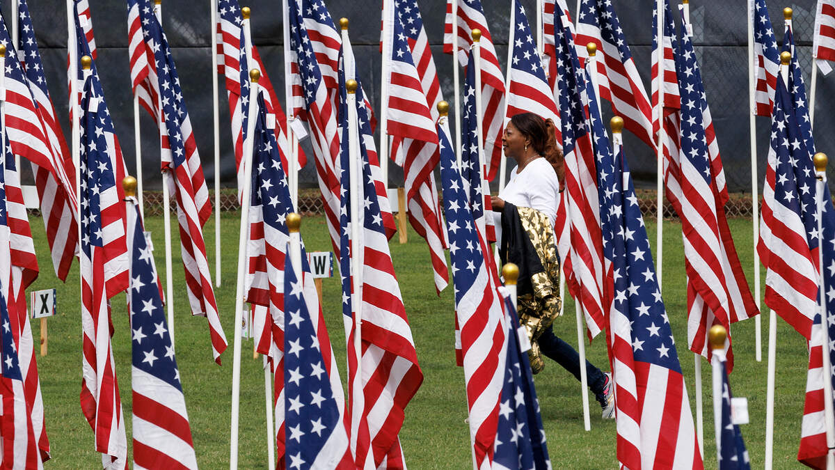 Estherine King Davis walks through the Wake County Field of Honor at the West Raleigh Baseball Complex in Raleigh, N.C. on Friday, May 24, 2024. The annual event, hosted by the Wake County Exchange Clubs, features over 500 American flags to honor veterans, law enforcement, first responders, medical professionals and community heroes. The flags will remain set up through Memorial Day weekend, culminating with a commemorative ceremony on Monday, May 27 at 1 p.m.
