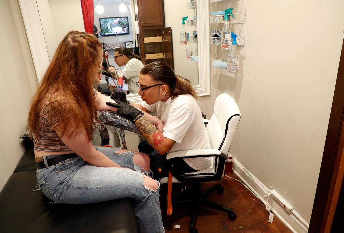 Kora Udell gets a tattoo from Eddie Cook-Hernandez at Area 51 Tattoo Studio in Raleigh, N.C., Friday, August 9, 2019.