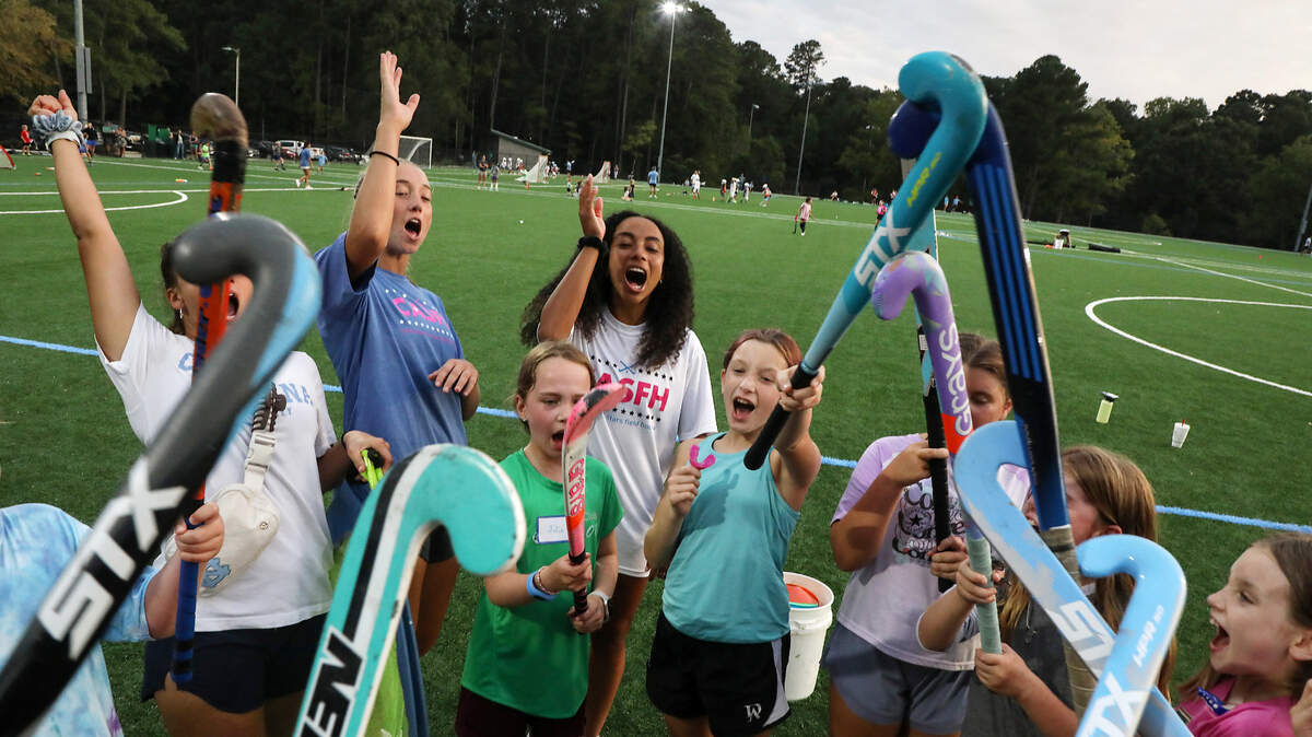 Athletes and coaches huddle at the close of a fall academy event held by Carolina All Stars Field Hockey on Wednesday, Sept. 13, 2023, at Cedar Falls Park in Chapel Hill, N.C.