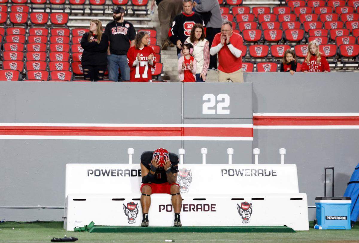 N.C. State defensive end Davin Vann (1) sits on the bench as fans try to console him after Duke’s 29-19 victory over N.C. State at Carter-Finley Stadium in Raleigh, N.C., Sat. Nov. 9, 2024.