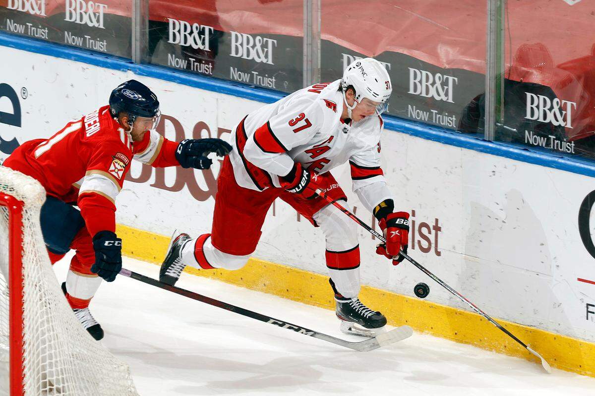 Florida Panthers center Jonathan Huberdeau (11) pursues Carolina Hurricanes right wing Andrei Svechnikov (37) as he skates with the puck behind the net during the third period of an NHL hockey game, Saturday, April 24, 2021, in Sunrise, Fla. (AP Photo/Joel Auerbach)