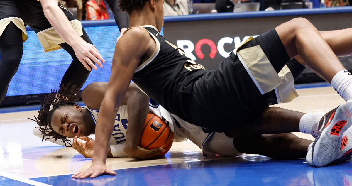 Duke’s Mark Mitchell (25) dives on a loose ball as Wake Forest’s Bobi Klintman (34) falls on him during the second half of Duke’s 75-73 victory over Wake Forest at Cameron Indoor Stadium in Durham, N.C., Tuesday, Jan. 31, 2023.