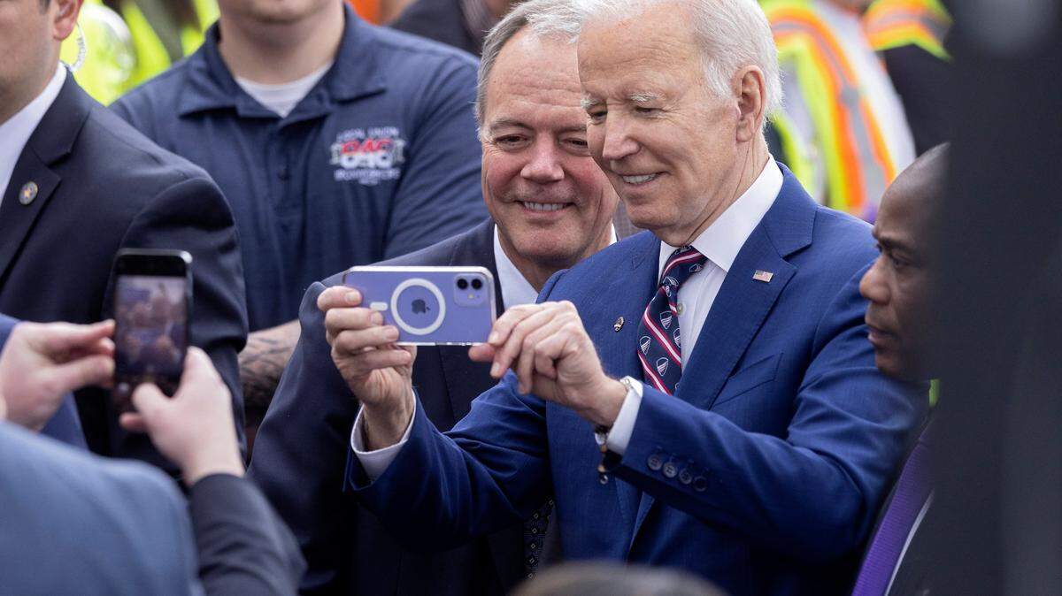 President Joe Biden takes a selfie with Wolfspeed CEO Gregg Lowe on Tuesday, March 28, 2023, in Durham, N.C. 