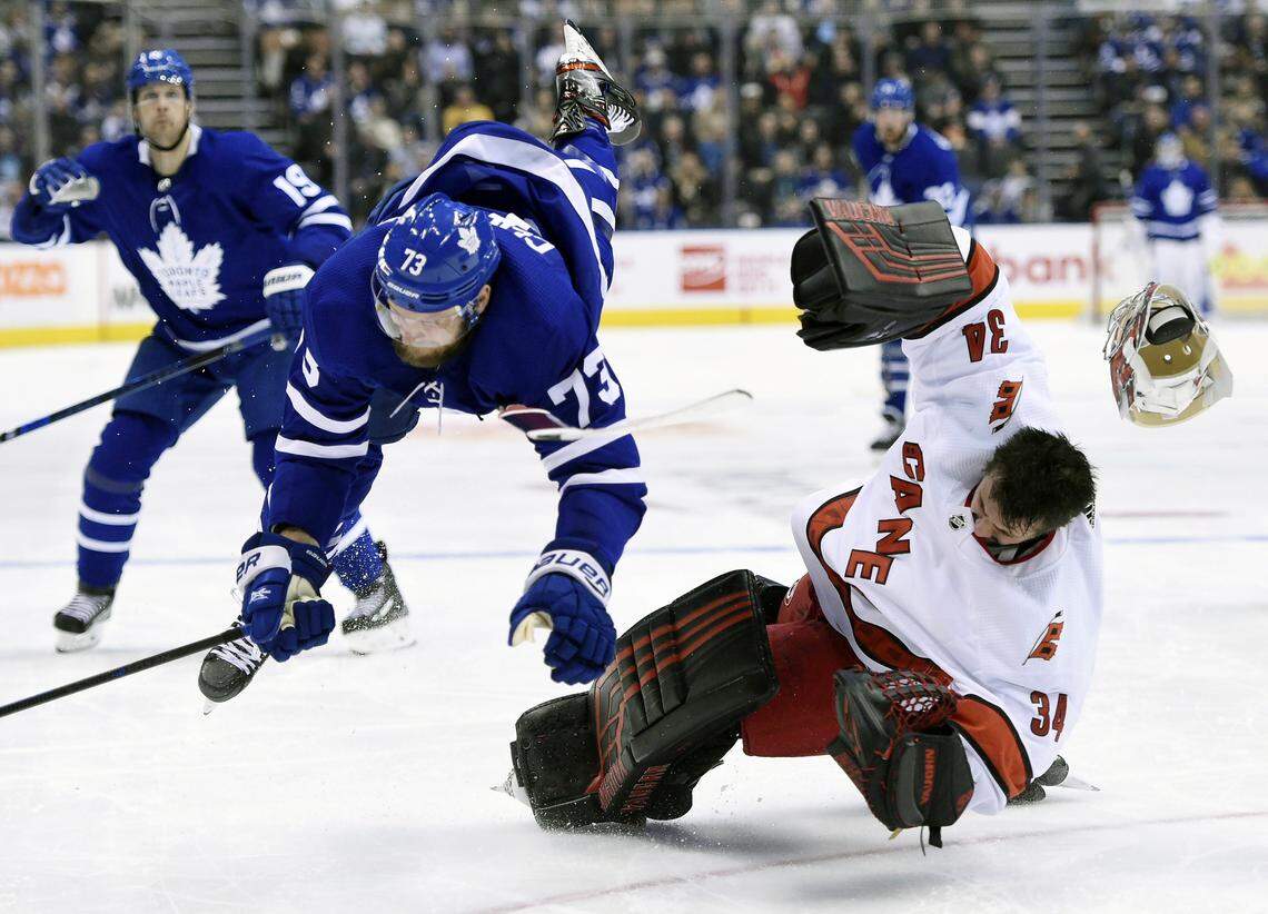 Carolina Hurricanes goaltender Petr Mrazek (34) hits the ice after Toronto Maple Leafs left wing Kyle Clifford (73) skated into him during second-period NHL hockey game action in Toronto, Saturday, Feb. 22, 2020.