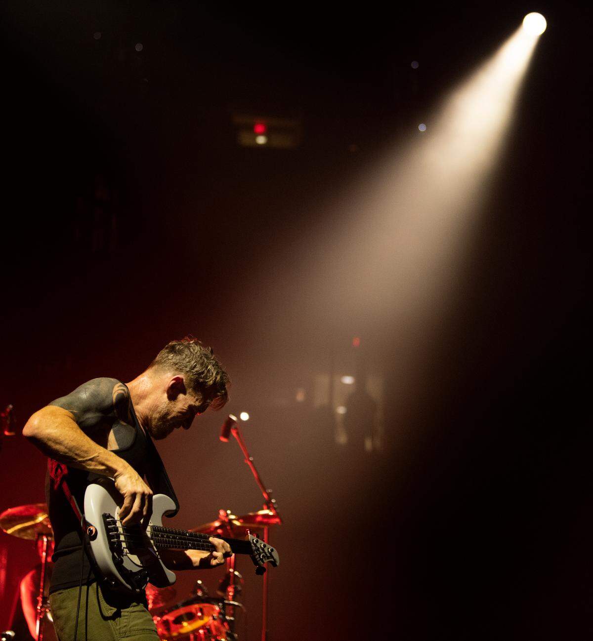 Rage Against the Machine bass player plays in the spotlight on “Bullet in the Head” during the band’s concert, Sunday night, July 31, 2022 at Raleigh, N.C.’s PNC Arena.