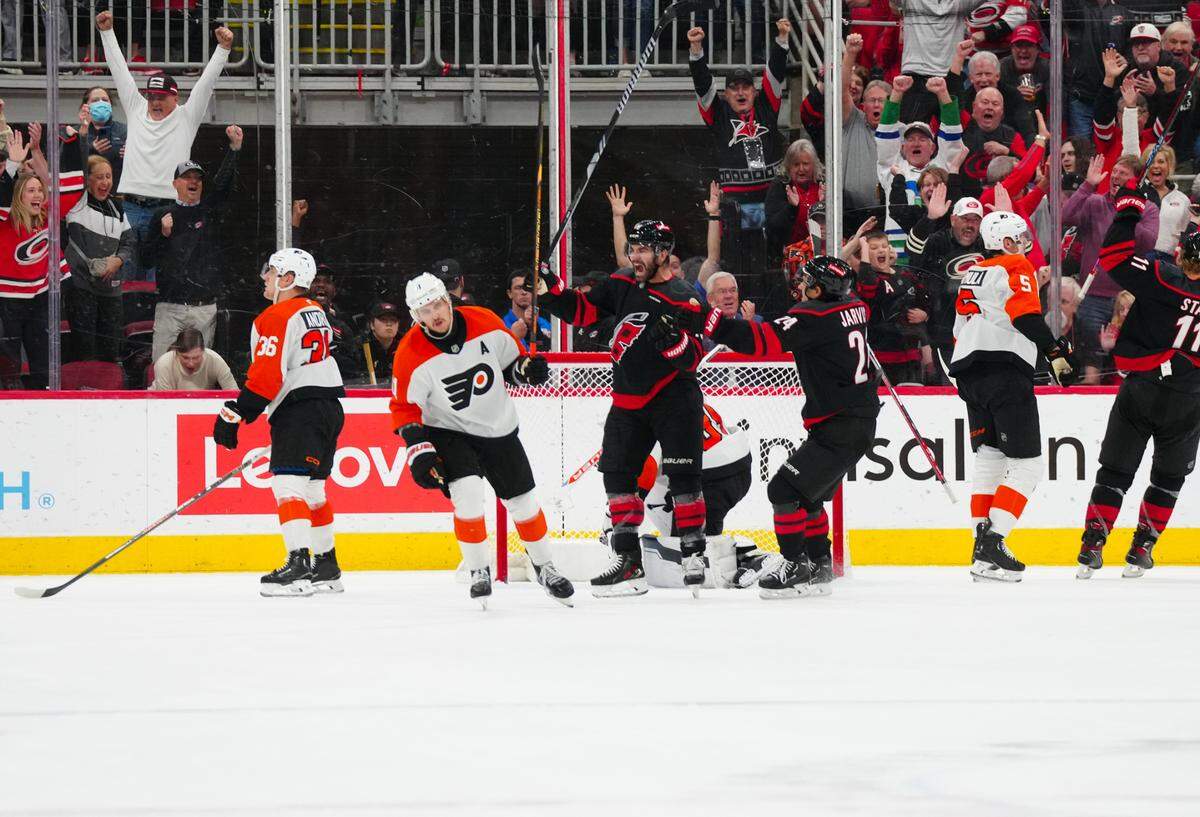 Carolina Hurricanes left wing Jordan Martinook (48) celebrates his goal with center Seth Jarvis (24) against the Philadelphia Flyers during the second period at Lenovo Center.