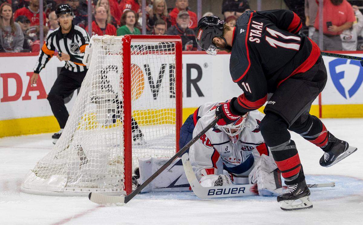 Washington Capitals goalie Logan Thompson (48) stops a scoring attempt by Carolina Hurricanes center Jordan Staal (11) in the first period during Game 4 of their series on Monday, May 12, 2025 at Lenovo Center in Raleigh, N.C.